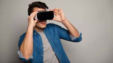 young handsome man wearing vr glasses 