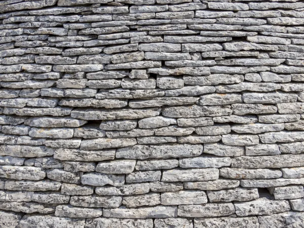 Una pared de piedra apilada — Foto de Stock