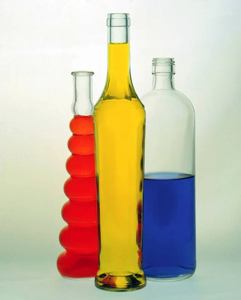 Beautiful glass bottles filled with colored liquids — Stock Photo, Image