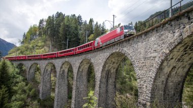 Glacier train on landwasser Viaduct bridge, Switzerland clipart