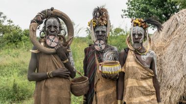 Üç Mursi kabile kadınlardan Etiyopya. Kadınların Mursi kabilesinin bir dudak plaka ve demir süslemeleri vardır