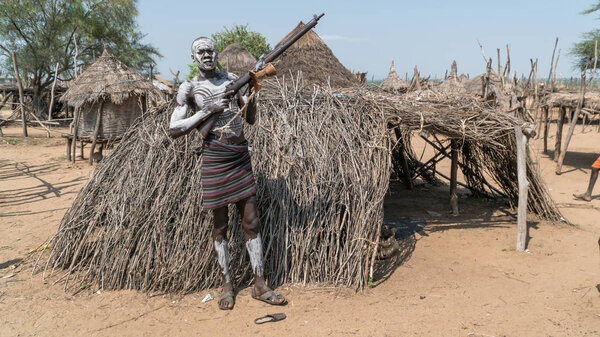 Portrait of a Mursi tribe man with his gun in Ethiopia