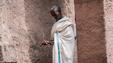 Unidentified pilgrim at one of the old rock churches from Lalibela clipart