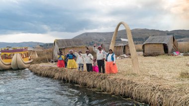 Unidentified people at the Floating island Isla Flotante, Titicaca lake, Peru clipart