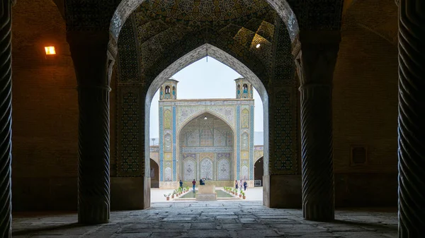 Туристы во дворе мечети Вакил, как видно из зала молитвы, Шираз, Иран — стоковое фото
