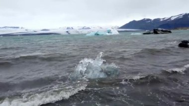 İzlanda 'daki Jokulsarlon Buzul Gölü' nün eriyen buzdağlarından kıyıdaki buz parçaları. Küresel ısınma ve iklim değişikliği kavramı