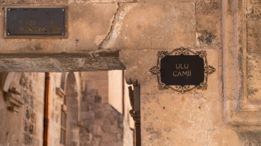 Mardin, Turkey - January 2020: Wall signage for Ulu Cami, also known as Great mosque of Mardin clipart