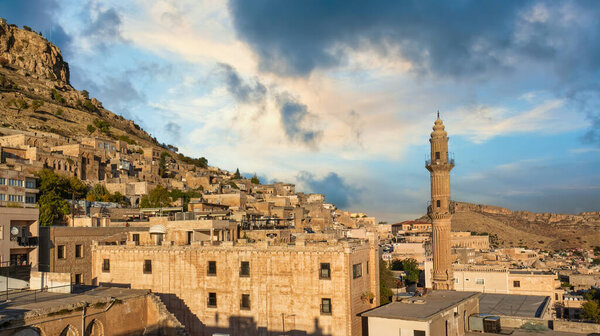 Mardin, Turkey - January 2020: Sehidiye mosque and its minaret with old Mardin cityscape