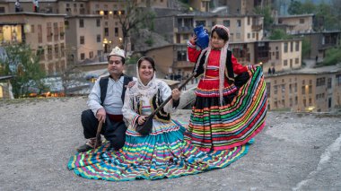Masuleh, Iran - May 2019: Iranian family in Persian traditional clothes at village of Masuleh in Gilan province clipart