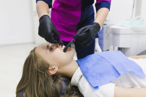 Jovem dentista e paciente — Fotografia de Stock