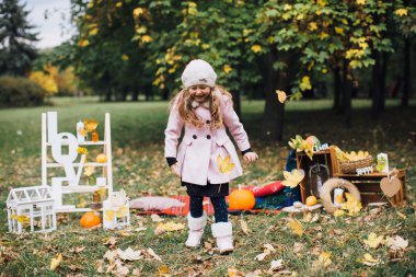 düşen yapraklar ile oynayan kız