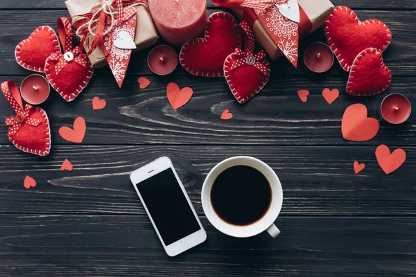 Corazones rojos y teléfono en mesa de madera — Foto de Stock