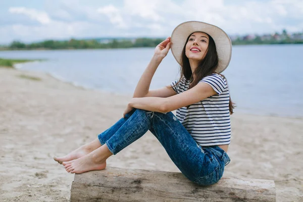 Vrouw met hoed op het strand — Stockfoto