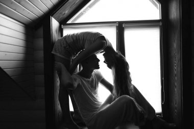 Genç çift pencere yakınındaki