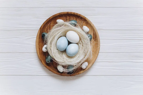 Easter nest on wooden plate