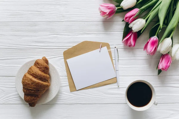 tulips with coffee and envelope
