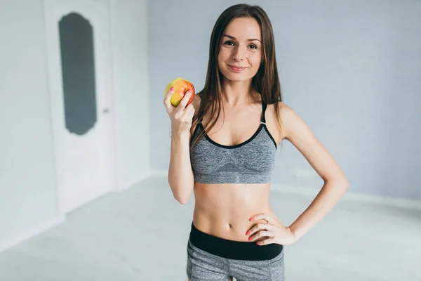 Фитнес девушка держит яблоко — стоковое фото