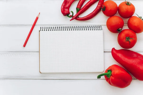 Notebook with vegetables and spices — Stock Photo, Image