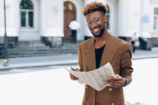 Man i en jacka med en tidning i city — Stockfoto