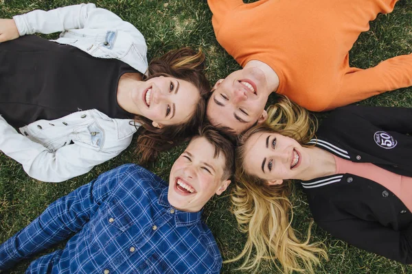 Teenagers lying on the grass in a summer — Stock Photo, Image