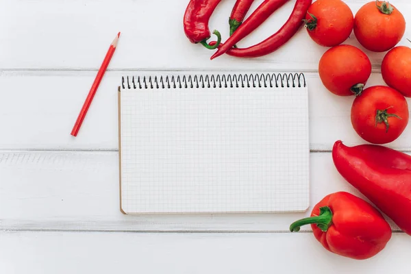 Notebook with vegetables and spices — Stock Photo, Image