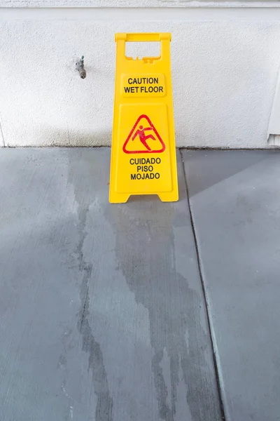 Slippery floor surface warning sign and symbol in building, hall — Stock Photo, Image