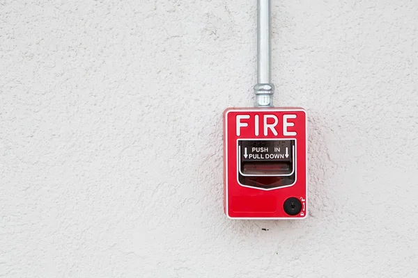 Red fire alarm switch at white wall — Stock Photo, Image