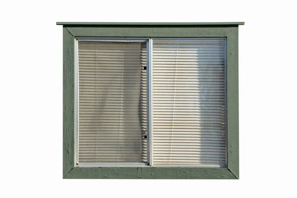 old window with plastic window blinds with wood walls.