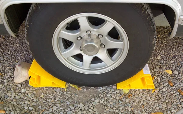 Yellow chock at the wheel — Stock Photo, Image