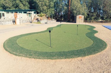 Golf hole in putting green. putting green is a mini golf course  clipart