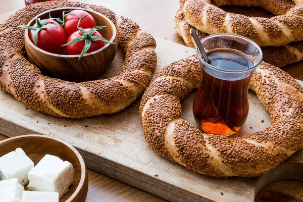 Turkish Bagel Simit with tea, cheese and cherry tomatoes.