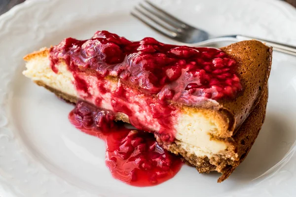 Homemade Raspberry Cheesecake in white plate