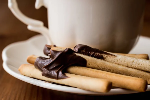 Grissini con crema de chocolate y té o café . — Foto de Stock