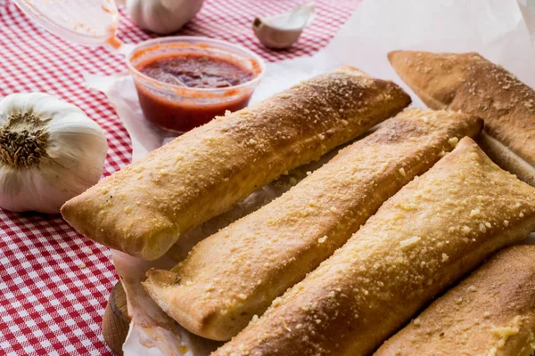 Garlic bread sticks with tomato sauce and parmesan cheese. — Stock Photo, Image