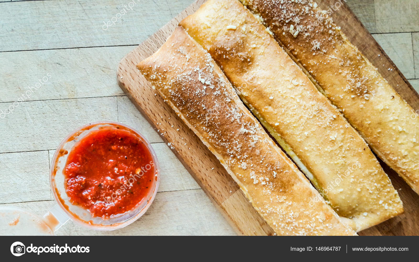 Garlic Bread Sticks with parmesan cheese and salsa dip sauce. Stock