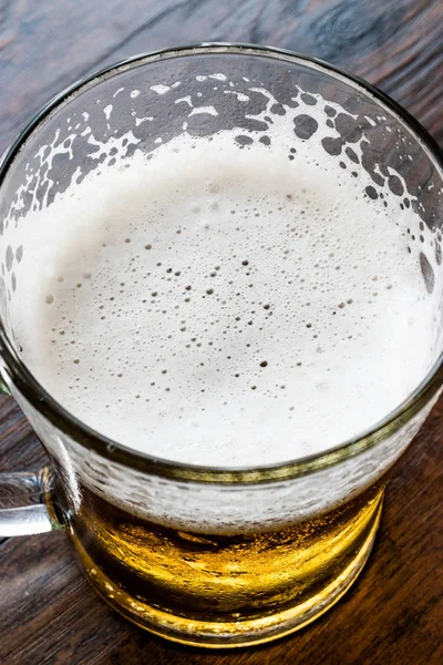 Glass of Beer on dark wooden surface. — Stock Photo, Image