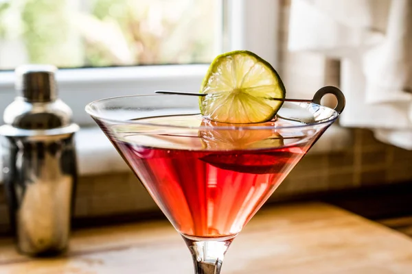 Cosmopolitan Cocktail with shaker on wooden surface. — Stock Photo, Image