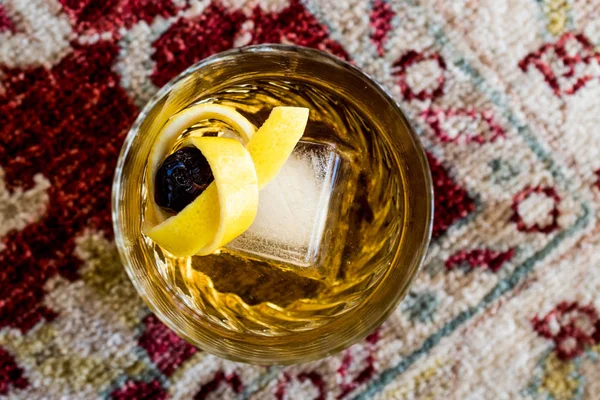 Old Fashioned Cocktail with lemon peel and ice