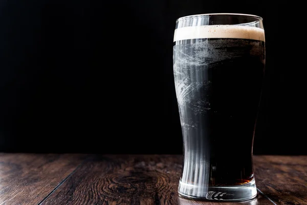 Dark Beer on wooden surface. — Stock Photo, Image