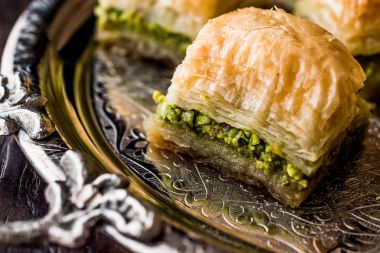 Türk tatlı Baklava gümüş tepsi üzerinde fıstıklı.