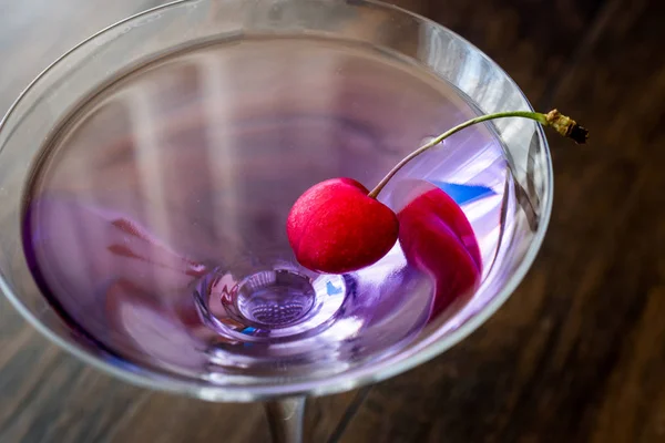 Blue Moon Cocktail with cherry on wooden surface. — Stock Photo, Image