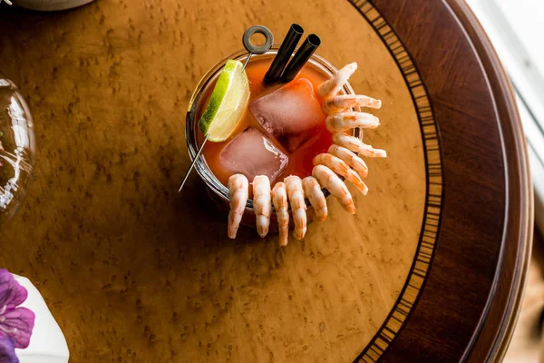 Shrimp Cocktail with red sauce, lime and ice.