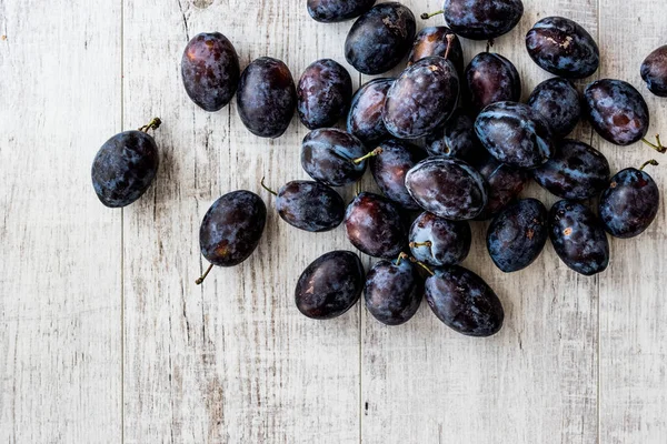 Damson Plum on white wooden surface. — Stock Photo, Image