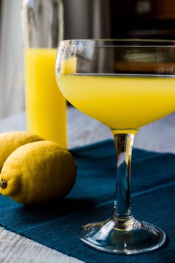 Limon likörü Limoncello limon beyaz tahta yüzeyi ile.
