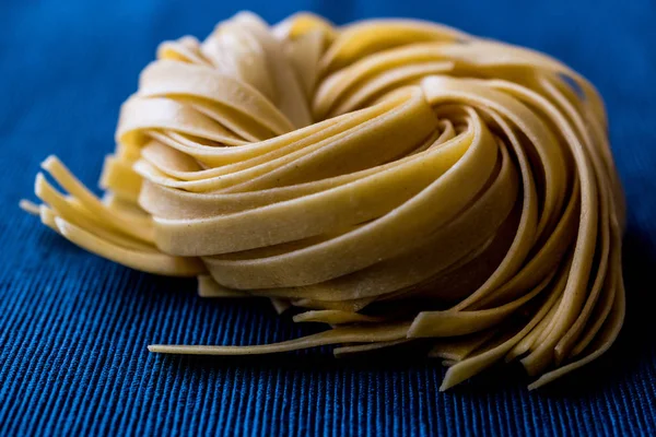 Raw Tagliatelle / Uncooked Pasta or Spaghetti — Stock Photo, Image