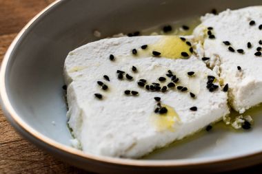 Cokelek or lor peyniri / Curd Cheese with olive oil and black cumin clipart