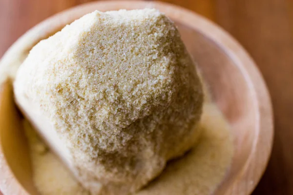 Raw unprepared semolina in wooden bowl. — Stock Photo, Image