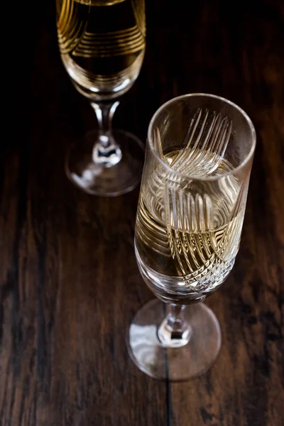 Champagne glasses on dark wooden surface. — Stock Photo, Image