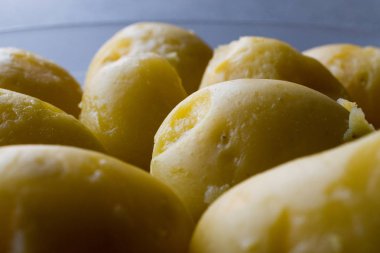 Gri yüzeyi cam kapta haşlanmış patates.