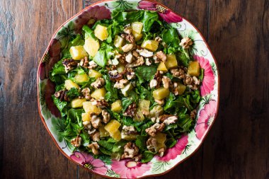 Ananas salata yeşillikleri ahşap bir yüzeyi ile.